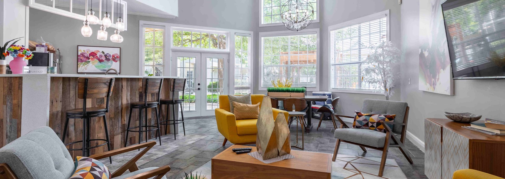 a living room with a large window and a couch at The Westmount at Three Fountains