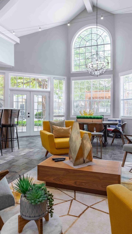 a living room with a large window and a couch at The Westmount at Three Fountains