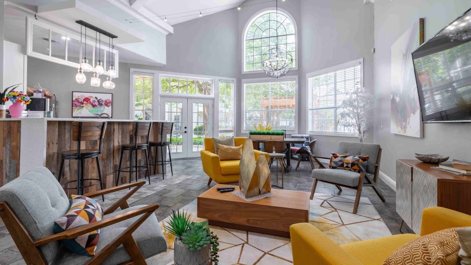 a living room with a large window and a couch at The Westmount at Three Fountains