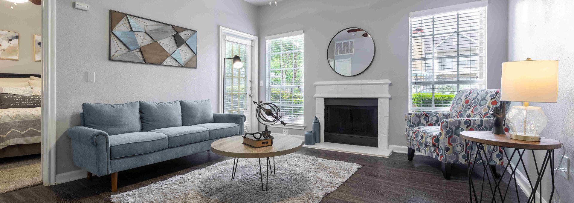 the living room has a ceiling fan and hardwood floors at The Westmount at Three Fountains