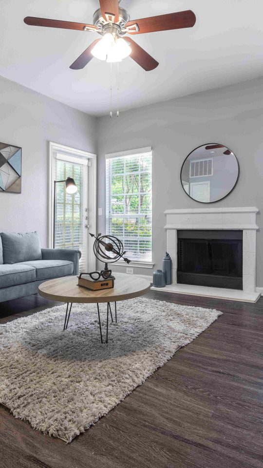 the living room has a ceiling fan and hardwood floors at The Westmount at Three Fountains