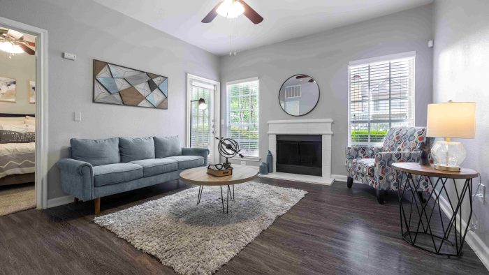 the living room has a ceiling fan and hardwood floors at The Westmount at Three Fountains