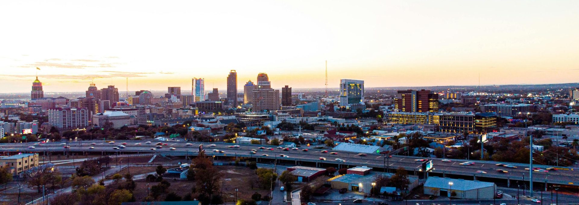 a city skyline at sunset with a highway in the foreground at The Westmount at Three Fountains