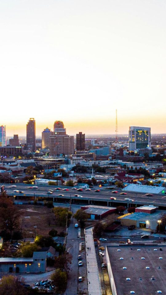 a city skyline at sunset with a highway in the foreground at The Westmount at Three Fountains